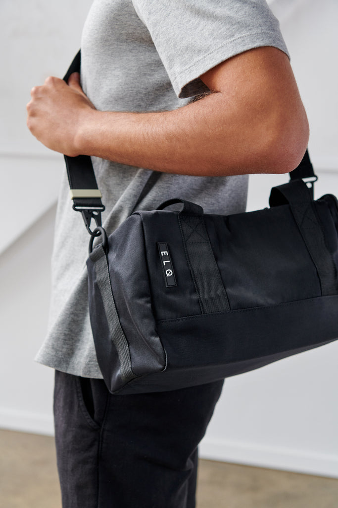 Model wearing unisex duffle bag for men and women