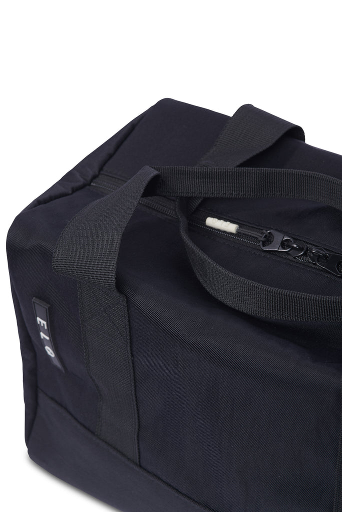 Close up of black compact duffle bag with zipper